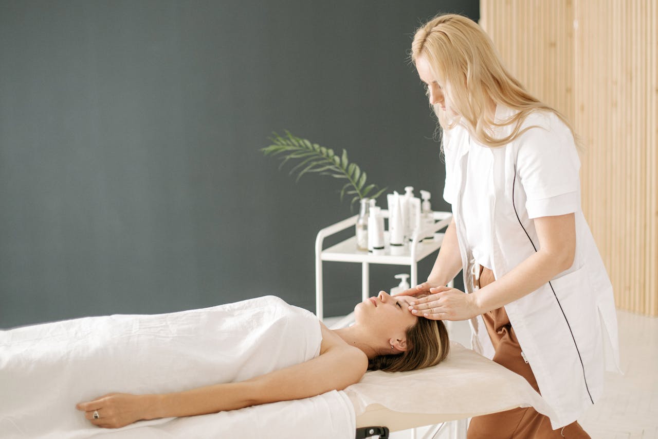 A woman receiving a relaxing face massage at a spa, promoting wellness and relaxation.